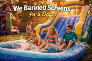 Kids playing on a large inflatable water slide at a backyard party in Jacksonville NC with no screens and active outdoor fun